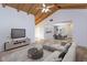 Open-concept living room boasts a vaulted ceiling, ceiling fan, and ample natural light to the dining room at 409 Oak Haven Dr # 409, Altamonte Springs, FL 32701