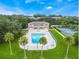 Aerial view of the community pool and surrounding green space and tennis courts on a sunny day at 4268 Lake Underhill Rd # 4, Orlando, FL 32803