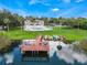 Aerial view of the building, the community pool, kayak racks and a wooden dock over the lake at 4268 Lake Underhill Rd # 4, Orlando, FL 32803
