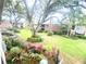 Lush courtyard view showcasing colorful flowers and mature trees, enhancing community charm at 4268 Lake Underhill Rd # 4, Orlando, FL 32803