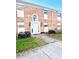 Two-story brick condo building with a white front door and manicured landscaping at 4268 Lake Underhill Rd # 4, Orlando, FL 32803
