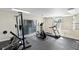 Spacious home gym with exercise equipment, rubber floor, and natural light at 4268 Lake Underhill Rd # 4, Orlando, FL 32803