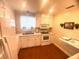 Bright kitchen with white cabinets, modern appliances, and a window view at 4268 Lake Underhill Rd # 4, Orlando, FL 32803