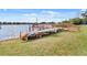 Scenic waterfront view featuring a wooden dock, boat storage, and serene lake at 4268 Lake Underhill Rd # 4, Orlando, FL 32803