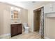 Functional bathroom with a shower, vanity, and storage shelving at 46 Smyrna Dr, Debary, FL 32713