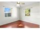 Cozy bedroom with hardwood floors, white walls, and view of backyard play set at 46 Smyrna Dr, Debary, FL 32713