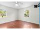 Bright bedroom with hardwood floors and two windows with natural light at 46 Smyrna Dr, Debary, FL 32713