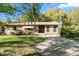 Quaint brick house featuring a neatly kept lawn, traditional windows and a front-facing driveway at 46 Smyrna Dr, Debary, FL 32713