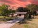 Charming one-story brick home with a well-maintained lawn and a long driveway at 46 Smyrna Dr, Debary, FL 32713