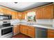 Traditional kitchen with wood cabinets, stainless steel appliances, and light countertops at 46 Smyrna Dr, Debary, FL 32713