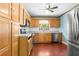 Traditional kitchen featuring wood cabinets, stainless steel appliances, and a bright window view at 46 Smyrna Dr, Debary, FL 32713