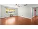Bright living room features hardwood floors, ceiling fan and a large window for natural light at 46 Smyrna Dr, Debary, FL 32713