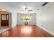 Bright living room features hardwood floors, ceiling fan and a large window for natural light at 46 Smyrna Dr, Debary, FL 32713