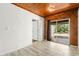 Bright living room with wood paneled ceiling, light colored tile floor and sliding glass doors to backyard at 46 Smyrna Dr, Debary, FL 32713