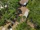 Aerial view of a home showcasing its brown roof surrounded by lush, mature trees at 4907 Lindsay Ct, Orlando, FL 32821