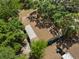 Overhead view of house featuring a brown roof, mature trees, and partial driveway at 4907 Lindsay Ct, Orlando, FL 32821
