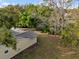Backyard featuring a canopy of trees and ample lawn space, with a partial view of the roof at 4907 Lindsay Ct, Orlando, FL 32821