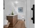 Bright bathroom featuring a wood vanity with a white countertop and decorative accents at 4907 Lindsay Ct, Orlando, FL 32821