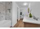 Bright bathroom featuring wood-look floors, stylish fixtures, and bathtub at 4907 Lindsay Ct, Orlando, FL 32821