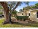 Landscaped front yard with a lush lawn and large tree at 4907 Lindsay Ct, Orlando, FL 32821