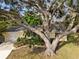 Charming home featuring a mature tree, well-manicured lawn, and a two-car garage at 4907 Lindsay Ct, Orlando, FL 32821