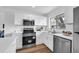 Bright kitchen with white cabinets, stainless steel appliances, and hardwood floors at 4907 Lindsay Ct, Orlando, FL 32821