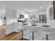 Stylish kitchen boasts white cabinets, stainless appliances, sleek breakfast bar with bar stool seating, and modern finishes at 4907 Lindsay Ct, Orlando, FL 32821