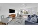 Cozy living room with a comfortable sofa, modern furniture, and a large TV at 4907 Lindsay Ct, Orlando, FL 32821