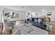 Open-concept living and dining area with modern furniture, hardwood floors, and natural light at 4907 Lindsay Ct, Orlando, FL 32821