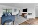 Open living space featuring modern furniture, a TV, and access to a screened in porch at 4907 Lindsay Ct, Orlando, FL 32821