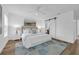 Main bedroom featuring a sliding barn door, hardwood floors, and ceiling fan at 4907 Lindsay Ct, Orlando, FL 32821