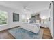 Bright main bedroom with wood floors, ceiling fan, and stylish, calming blue artwork at 4907 Lindsay Ct, Orlando, FL 32821