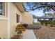 Side yard with stone decorations, lush plants and a cozy patio at 4907 Lindsay Ct, Orlando, FL 32821