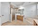 A well-lit bathroom featuring a walk-in shower, tub, wooden cabinets and neutral tile flooring at 5055 Coveview Dr, St Cloud, FL 34771