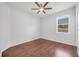 Cozy bedroom with hardwood floors, ceiling fan, and natural light from the window at 5055 Coveview Dr, St Cloud, FL 34771