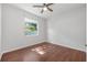Bedroom featuring hardwood floors, ceiling fan, and natural light from the window at 5055 Coveview Dr, St Cloud, FL 34771