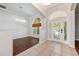 Bright foyer featuring tile flooring, arched doorways, decorative lighting, and a view of the front door at 5055 Coveview Dr, St Cloud, FL 34771