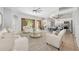 Open concept living room with dining and kitchen areas featuring neutral color palette at 5055 Coveview Dr, St Cloud, FL 34771