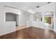 Spacious living room showcasing hardwood floors, elegant lighting, and seamless transitions to adjacent rooms at 5055 Coveview Dr, St Cloud, FL 34771