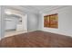 Open living room featuring hardwood flooring, arched doorways, and a large window providing natural light at 5055 Coveview Dr, St Cloud, FL 34771