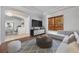 Cozy living room featuring modern decor, stylish furniture, and view into the dining room at 5055 Coveview Dr, St Cloud, FL 34771