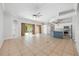 Bright open living space with tile flooring, a central island, and sliding glass doors leading to the outdoors at 5055 Coveview Dr, St Cloud, FL 34771