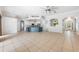 Open living space with tile flooring, a center island kitchen, and natural light streaming in from the front entryway at 5055 Coveview Dr, St Cloud, FL 34771