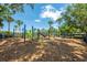 Community playground with various play structures and palm trees, a fun and safe place for children to play at 5055 Coveview Dr, St Cloud, FL 34771