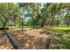Swing set surrounded by mature trees, creating a shaded and peaceful spot for recreation and play at 5055 Coveview Dr, St Cloud, FL 34771