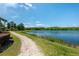 Scenic walking path alongside a tranquil lake surrounded by trees, perfect for a refreshing stroll at 5055 Coveview Dr, St Cloud, FL 34771