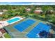 Aerial view showcasing a community pool, well-kept landscaping, and a tennis court at 5268 Middle Ct # 111, Orlando, FL 32811