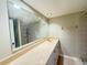 Bathroom featuring a large mirror over a vanity with ample countertop space and tile flooring at 5268 Middle Ct # 111, Orlando, FL 32811