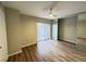 Bedroom featuring a ceiling fan, wood flooring, and a mirrored closet door at 5268 Middle Ct # 111, Orlando, FL 32811