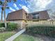 Inviting townhouse featuring a unique roof, private fence, and well-maintained front yard at 5268 Middle Ct # 111, Orlando, FL 32811